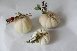 3 white ornamental pumpkins with dried flowers