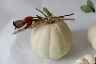 3 white ornamental pumpkins with dried flowers